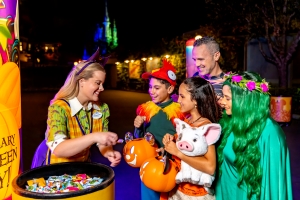 Guests being given candy at Disney World's Mickey's Not-So-Scary Halloween Party