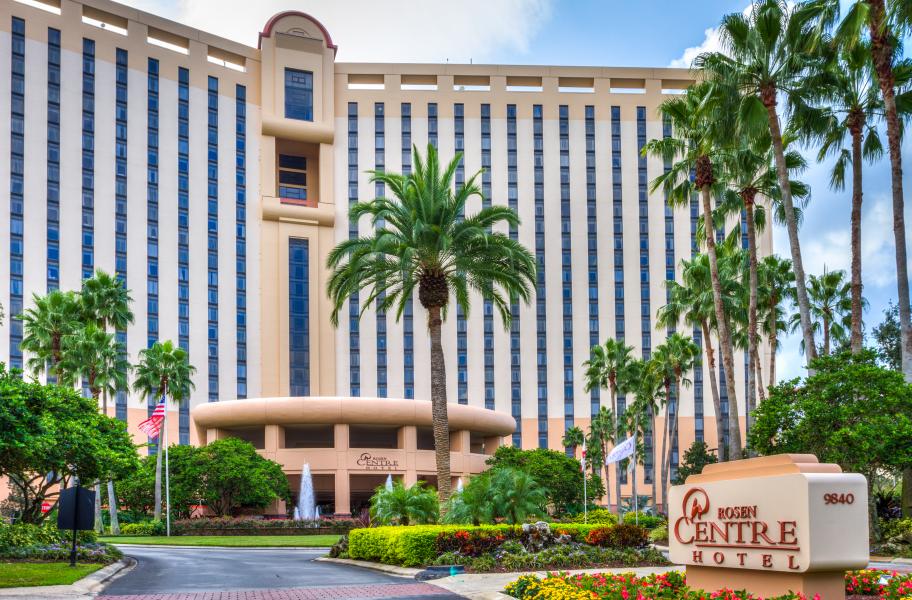 The exterior of Rosen Centre, standing tall with palm trees and the front sign. Rosen Centre is a great hotel for convention travelers who want more than just a room.