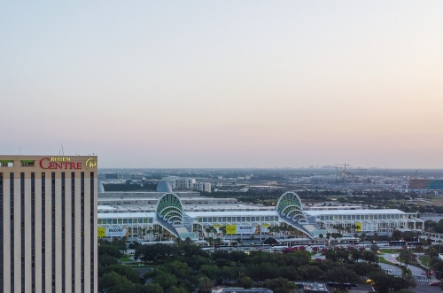 An aerial shot of the Orange County Convention Center (OCCC) at dusk with the corner of Rosen Centre in the bottom corner of the photo. 