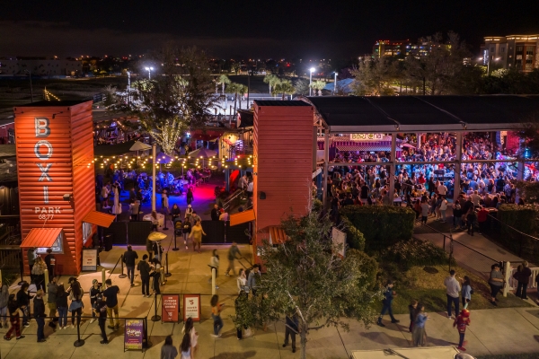 An aerial shot of an outdoor food and concert venue with two orange towers labeled Boxi Park.