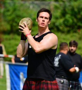 Central Florida Scottish Highland Games - Man in Red Kilt Competing in Stone Put