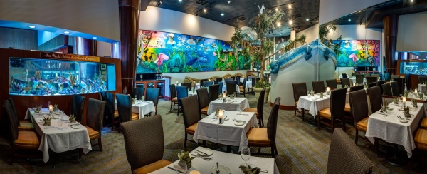 The inside of Everglades Restaurant with large swamp animals and colorful murals.