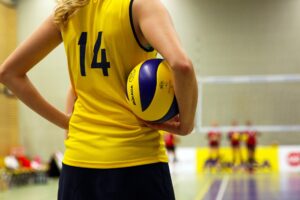 A female basketball player stands on an indoor court. Orlando will host one of the best girls volleyball competitions at the Orange County Convention Center in June 2023.