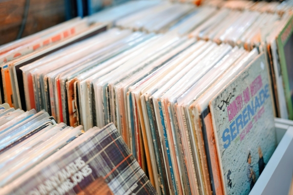 A close-up of a display of used vinyl records for sale.
