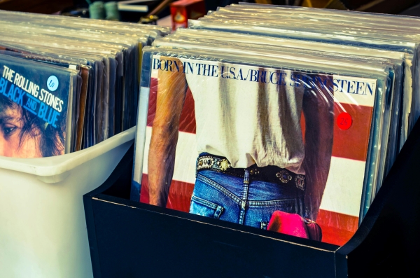 A close-up of Bruce Springsteen's Born in the USA record at the front of a row of records for sale.