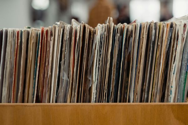 A close up of a row of used records from the side.