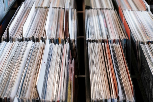 An overhead view of shelves of used records divided by wooden dividers.