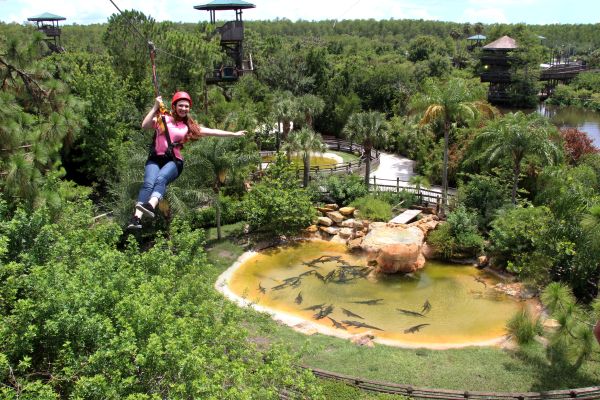 A woman riding the Screamin' Gator Zip Line, one of the best zip lining experiences in Orlando.