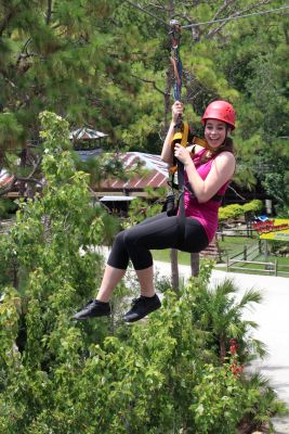 A woman riding the Screamin' Gator Zip Line at Gatorland.