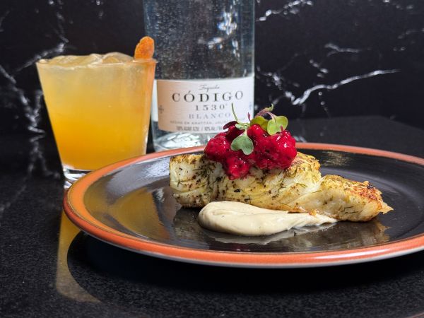 Seared halibut paired with Tropical Saffron Paloma.
