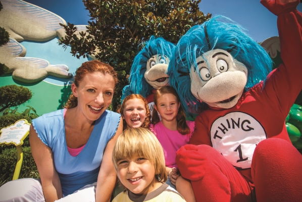 A woman and three children pose with Thing 1 and Thing 2 characters at Seuss Landing. 