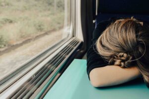 Woman gets some sleep while traveling on a train. 