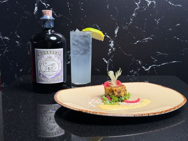 Smoked trout cake paired with Monkey 47 Garde Collins.