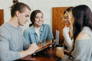 Four business professionals meeting up to network with one another. 