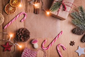 A stock image of a generic table set for Christmas Dinner with candy canes and pine cones.