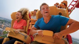 Two people riding a rollercoaster in Spring for a perfect Orlando vacation