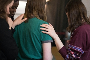 three women entrepreneurs uplifting one another at a networking event. 